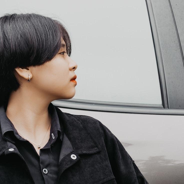 Avery Chen, Lead Design Curator at HarborFoilMeadow, reviewing corporate floral arrangements